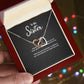 To My Sister Interlocking Hearts necklace — gift presentation view