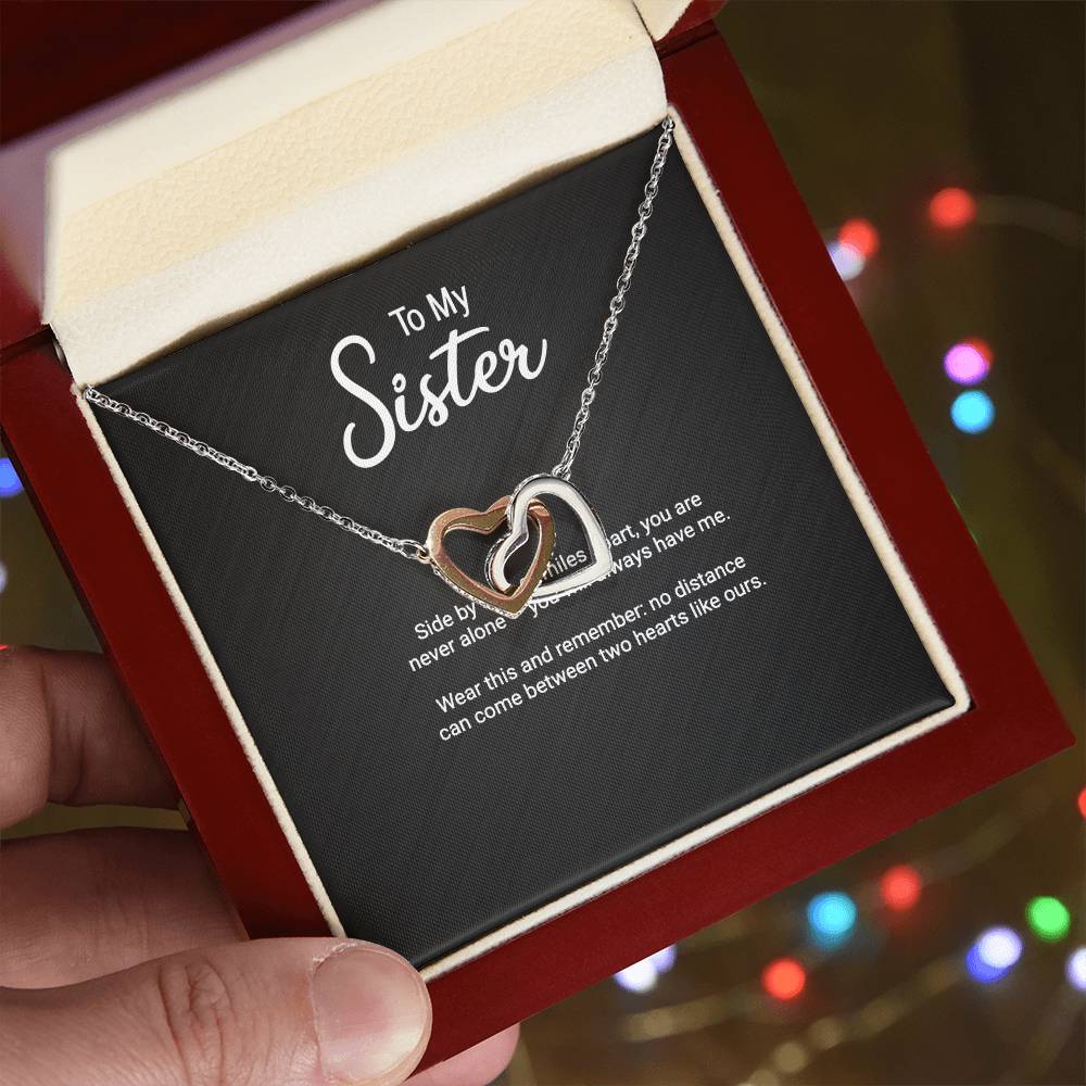 To My Sister Interlocking Hearts necklace — gift presentation view