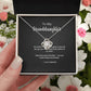 To My Granddaughter Love Knot necklace with 'Always in My Heart' message card, held in hand in gift box