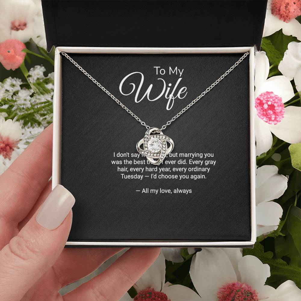 To My Wife Love Knot necklace with 'I'd Choose You Again' message card, held in hand in gift box